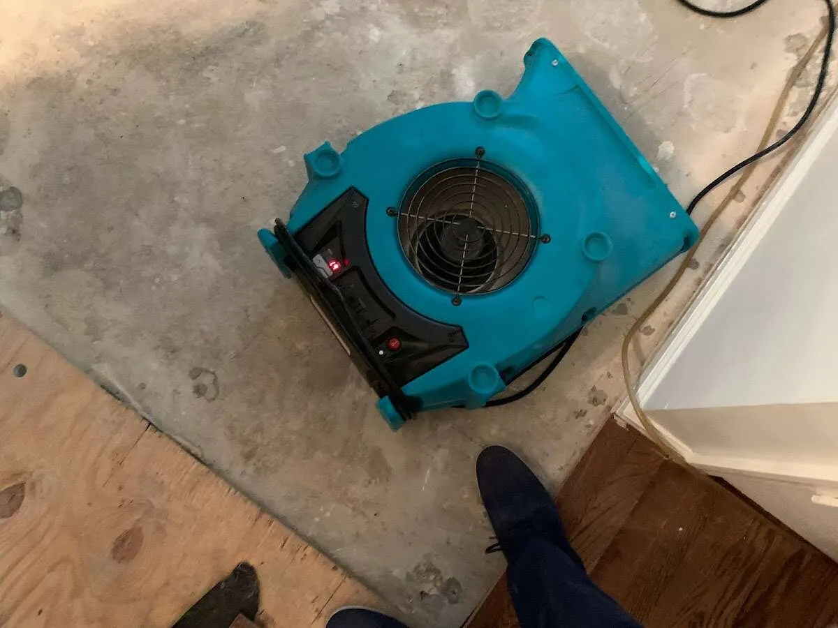 Air mover drying subfloor during Commercial Water Damage Restoration in Iron Mountain